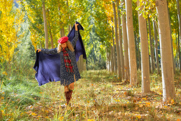 lady walks through the forest in her foulard