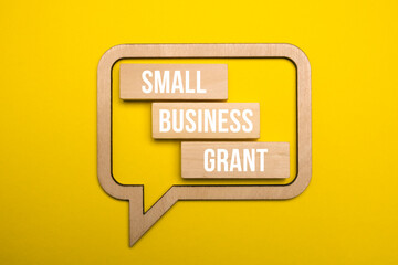 Business and finance concept. On a yellow background, speech bubble with the inscription - Small Business Grants
