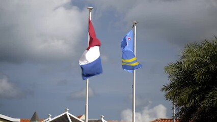 Aruba and Netherlands Flag Blowing in the Wind in Oranjestad, Aruba