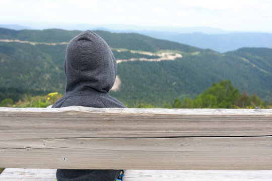 Kid sitting on bench on Lago-Naki plateau
