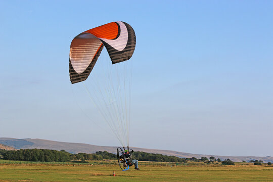 	
Paramotor pilot landing in the hills of Wales