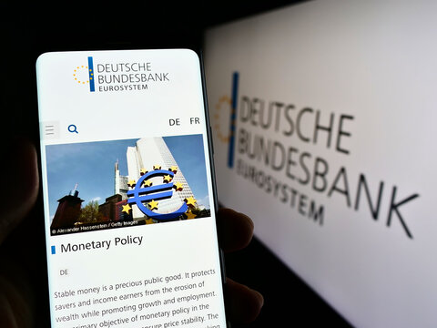 Stuttgart, Germany - 09-19-2022: Person holding smartphone with webpage of German central bank Deutsche Bundesbank on screen in front of logo. Focus on center of phone display.