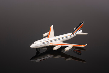 Plastic model of an airplane on a black background.
