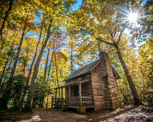 The historic Linville Cabin in Linville, North Carolina surrounded by a beautiful and colorful autumn forest. 