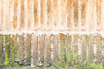 Background texture of old, worn and weathered brick wall with moss, horizontal foreground and copy space
