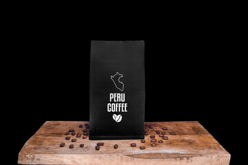 Peru coffee beans and black package on wooden board with black isolated background