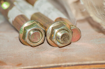Hexagonal nut and washer on metal galvanized anchor bolt end on black background. Artistic detail...