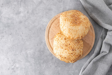Top view of a pita bread on wooden board with copy space
