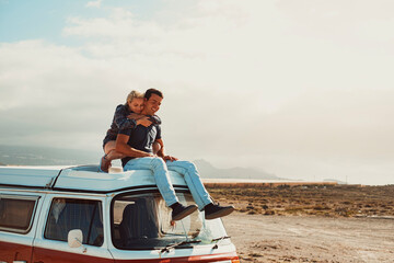 Young couple of traveler enjoy van life vehicle travel adventure together hugging and loving...