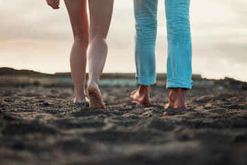 Fototapeta na wymiar Close up and legs view for man and woman walking together on the ground in barefoot natural style. Concept of love and life together. Nudism. Couple of people walk. Sky in background. Travel.