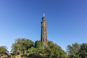 Obraz premium Bottom-up view of Nelson Monument on Calton Hill in Edinburgh, Scotland. It is built in honor of Admiral Horatio Nelson.