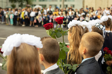 Knowledge Day in Russia. Children with flowers. First graders on September 1. Students in front of...