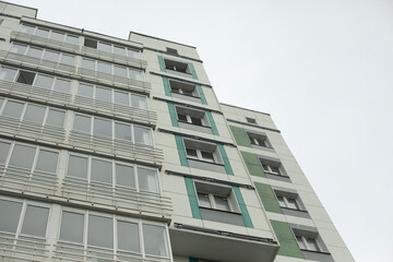 Building in city. Architecture details. Lots of windows in house.