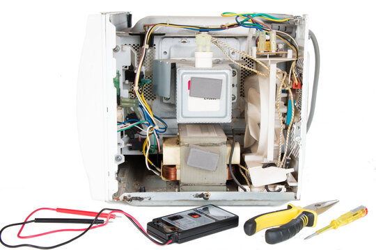 disassembled microwave oven, magnetron repair, on an isolated background
