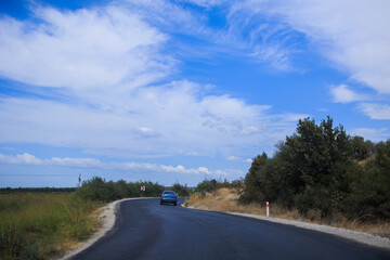 Naklejka premium Highway wide road, transport and blue sky with clouds on a summer day