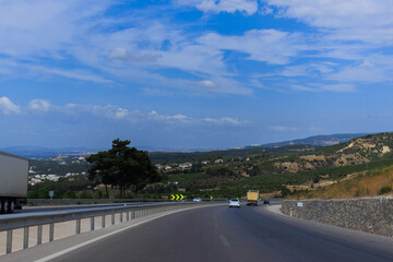 Fototapeta premium Highway wide road, transport and blue sky with clouds on a summer day