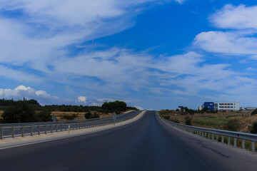 Highway wide road, transport and blue sky with clouds on a summer day
