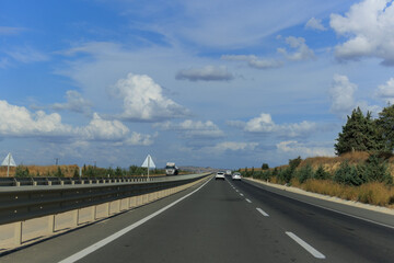 Highway wide road, transport and blue sky with clouds on a summer day