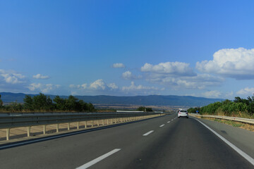 Highway wide road, transport and blue sky with clouds on a summer day
