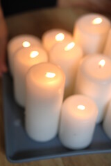 Women's hands light candles with matches. Yoga practice and fire in the palms