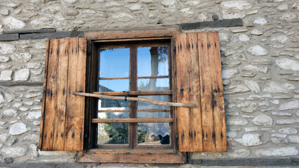 Birgi, Ödemiş, İzmir, Turkey - 09.18.2022 Wooden window of a stone house in Birgi