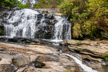 Waterfall with beautiful rocks and splashing water in Thailand