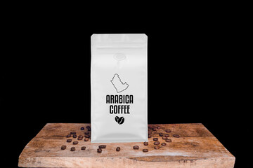 Arabica coffee beans and white package on wooden board with black isolated background