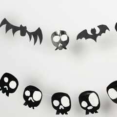 Bats and skulls black on white background, place to write greeting.