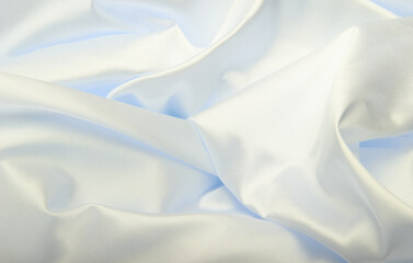 White beige pearl wave fabric silk. Abstract texture horizontal copy space background.