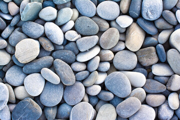 Abstract background with round pebble stones. Stones beach Top view.