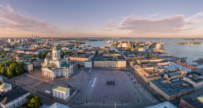 Helsinki Cityscape. Finland. Helsinki Cathedral, Old Town and South Harbor and Market Square Kauppatori in Background. Sunset Colors. Drone Point of View.