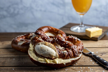 German Pretzel called Brezel,pastry from Southern with butter and glass of beer Germany,very popular in Oktoberfest.