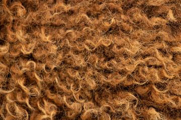 Brown sheep wool as a background, natural wool, live sheep