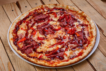 tasty pizza on the wooden background