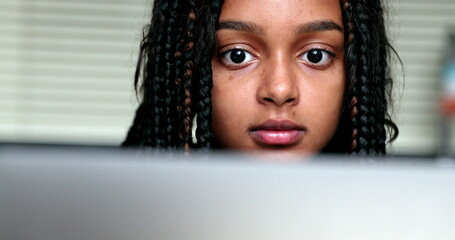 Black girl child face looking at computer screen monitor