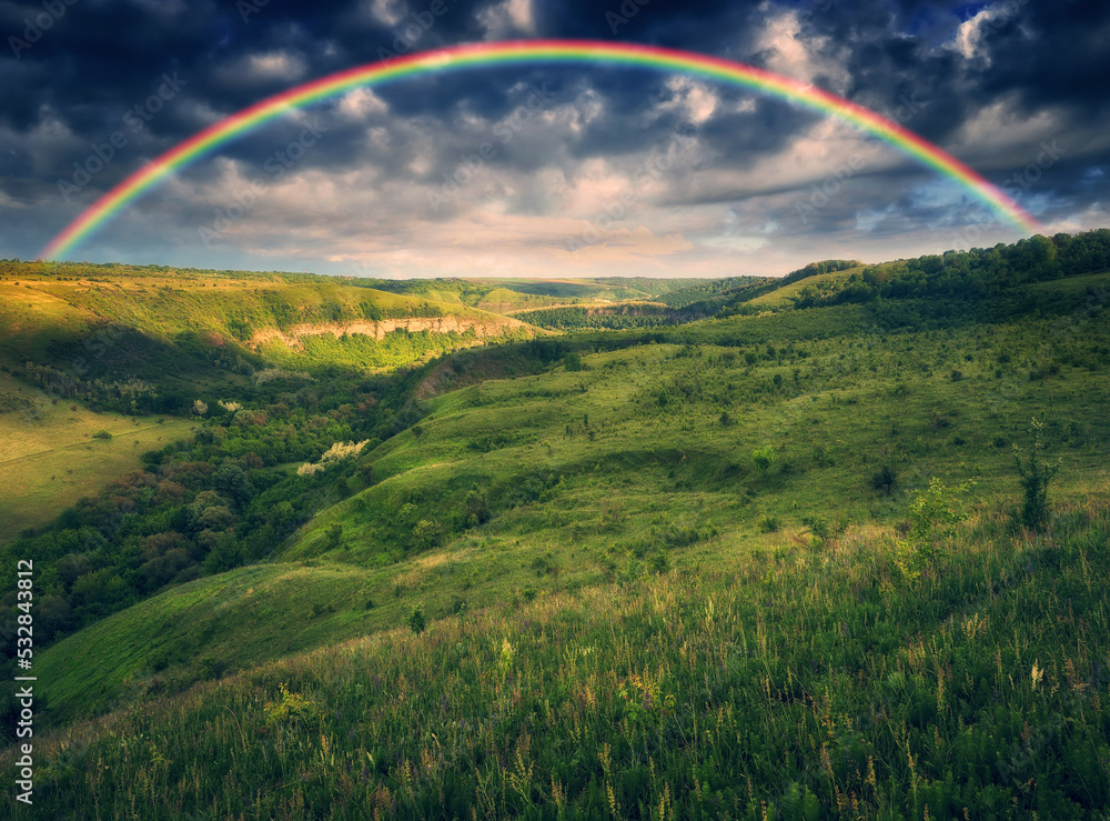 Wall mural Beautiful landscape with a rainbow in the sky. spring landscape