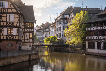 Fototapeta na wymiar Traditional old alsatian houses from Pont st. Martin on a canal in Petit Venice (Small Venice) in Stasbourg in Alsace in the department of Haut-Rhin of the Grand Est region of France