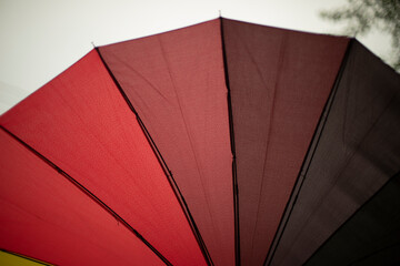 Red umbrella from rain. Red gradient. Umbrella needles and fabric.