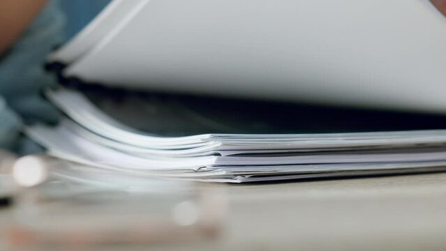 Zoom of woman hands, organise paper or search for document in paperwork stack on table at work. Lady use fingers to find report, information on pages or file on desk while working in closeup portrait