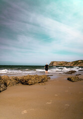 Mature woman walking on the beach alone. Copy space.