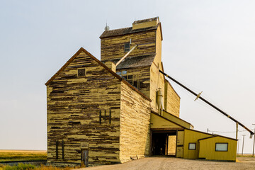 Old white wooden grain elevator by the tracks. Skiff, Alberta, Canada © David