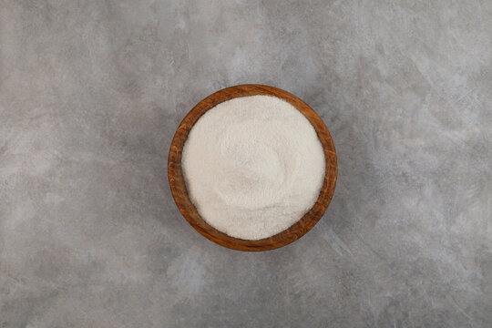 Lupin Flour in wooden bowl on grey background, top view. Versatile Flour fine grinding from Nutritious Andean Lupin Beans. Gluten free food, nutritional digestible product