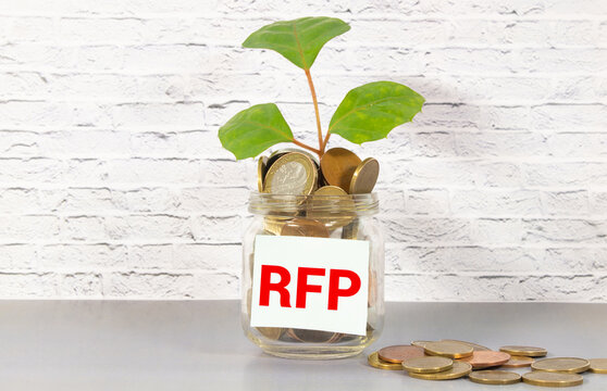 RFP- Request For Proposal word written on a notebook with block magnifier and pen , business concept.