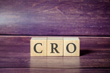 CRO text on wooden blocks and brown background