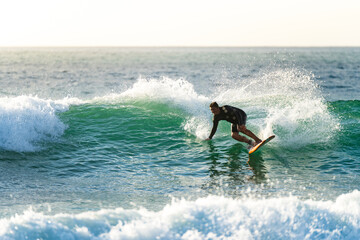 Surfer in action at sunset