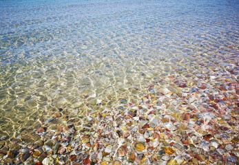 Fototapeta na wymiar sea view with stones, beautiful water surface with sunlight