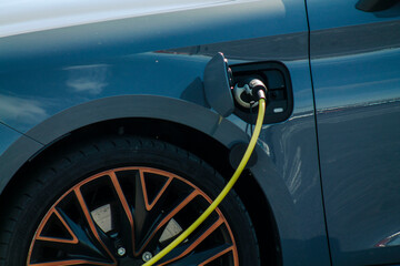 Charging modern electric car from station, closeup