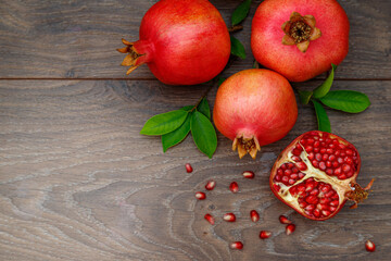 Pomegranates on a wooden table, the symbol of the Jewish new year - Rosh Hashanah. Top view