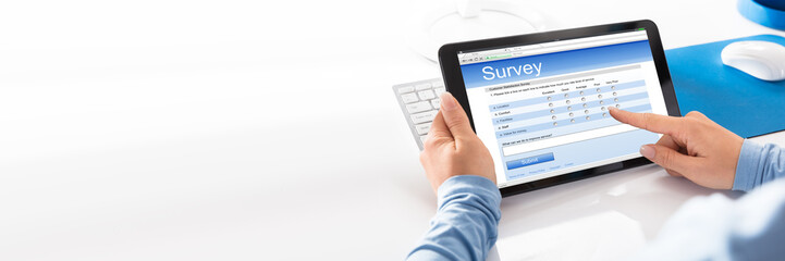 Woman Holding Digital Tablet With An Online Survey Form
