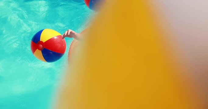 Happy child having fun on summer vacation. Kid playing in swimming pool. Active healthy lifestyle concept. Slow motion